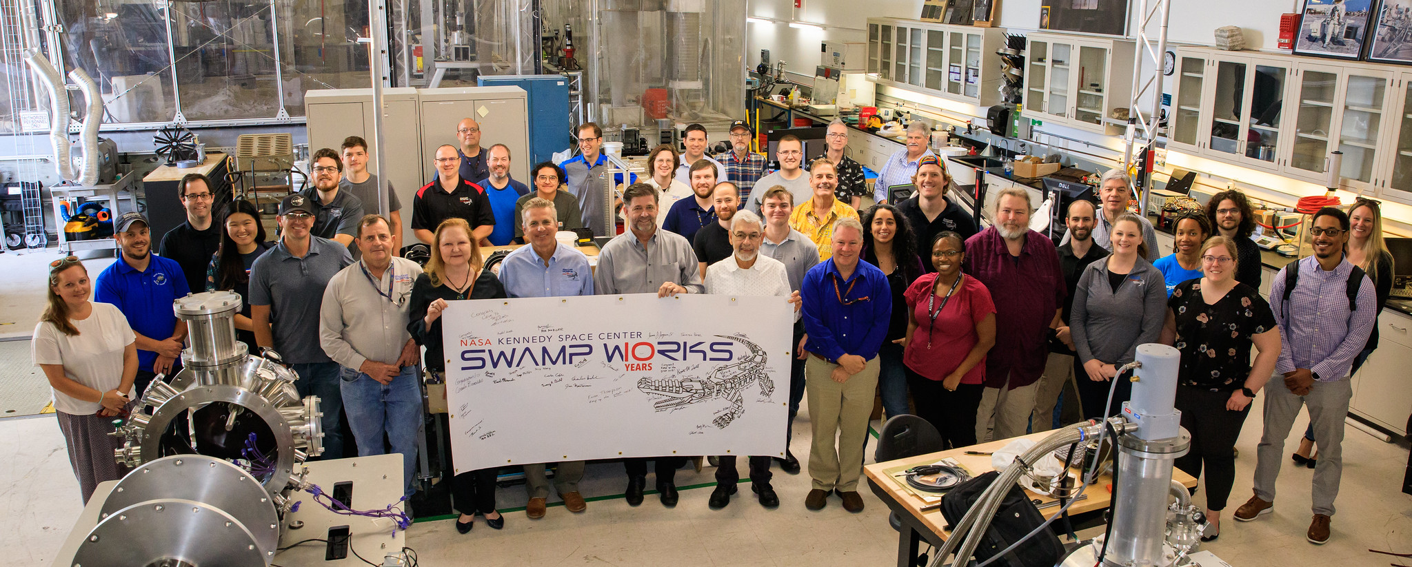 Swamp Works team poses for group photograph inside Swamp Works laboratory area at NASA’s Kennedy Space Center, Florida on April 21, 2023
